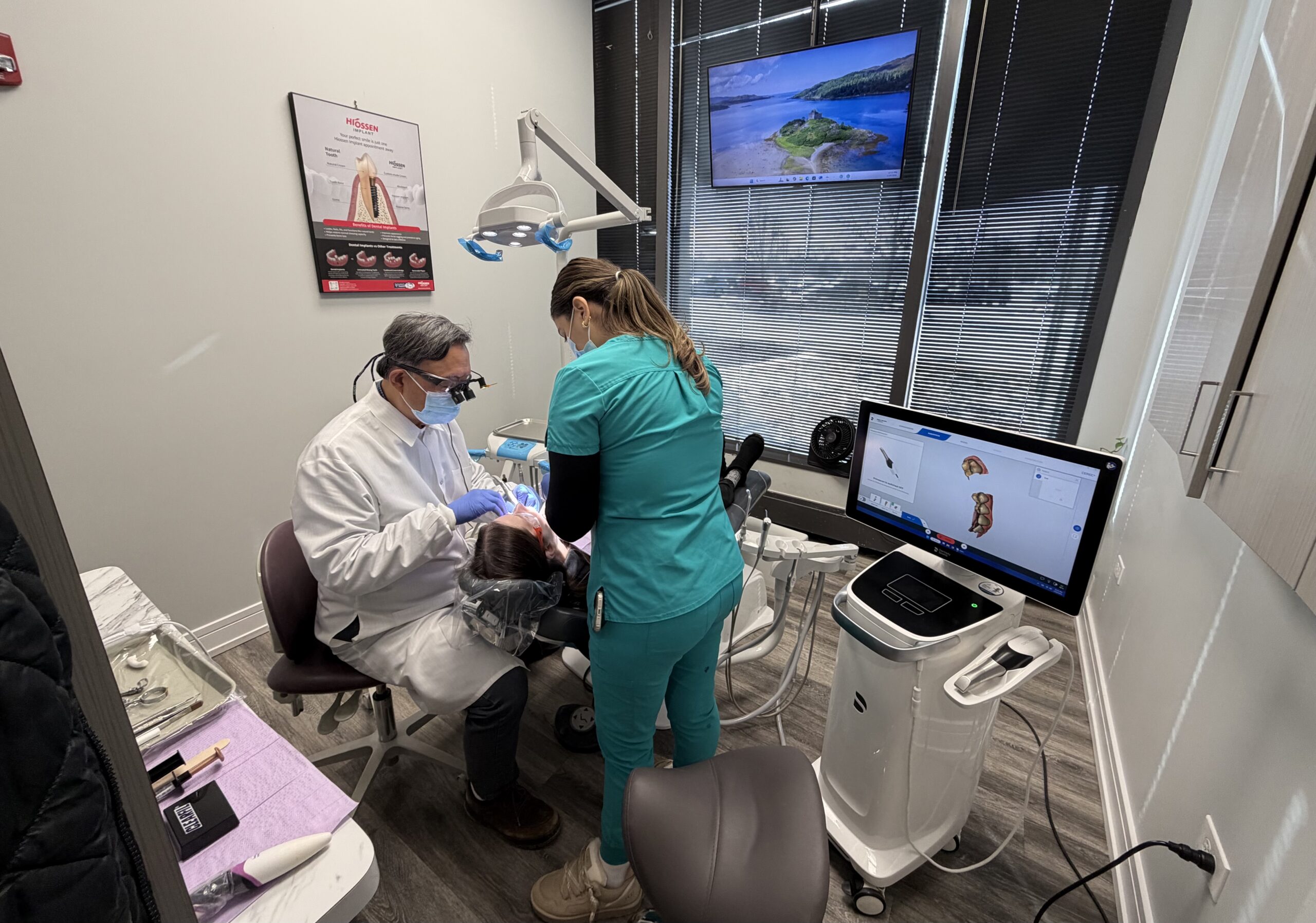 dr song and dental assistant working on patient