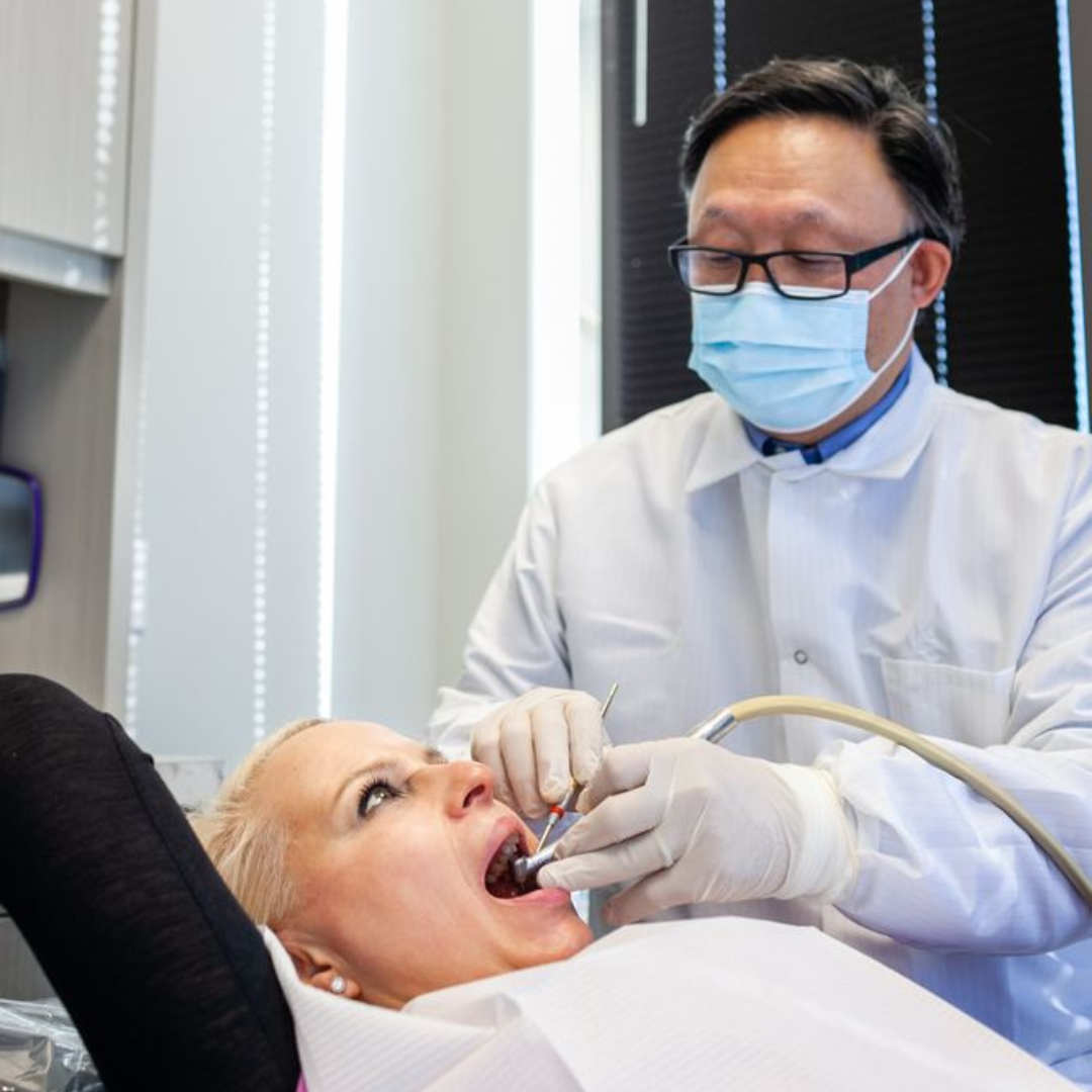 dr song working on a patient with a mask on