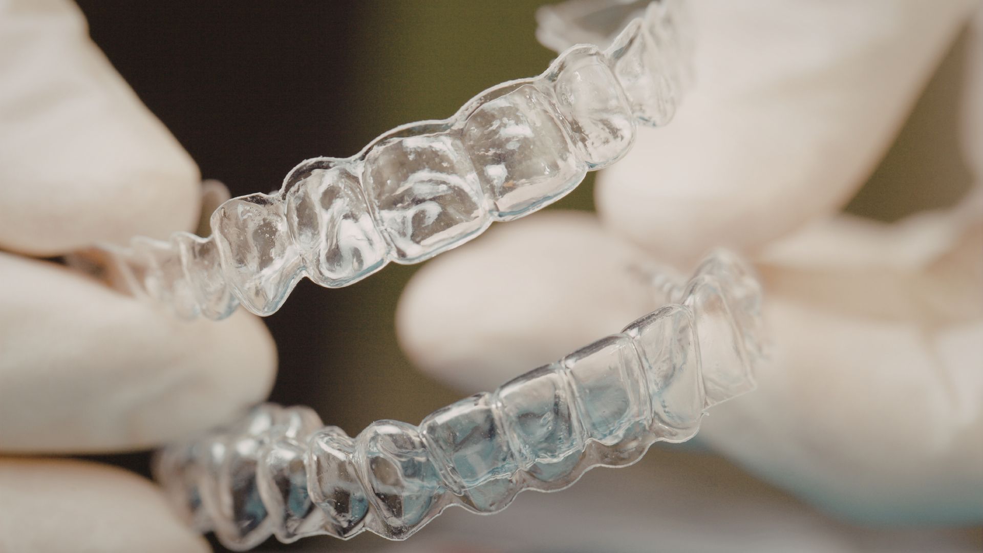 clear aligners in dentist hand