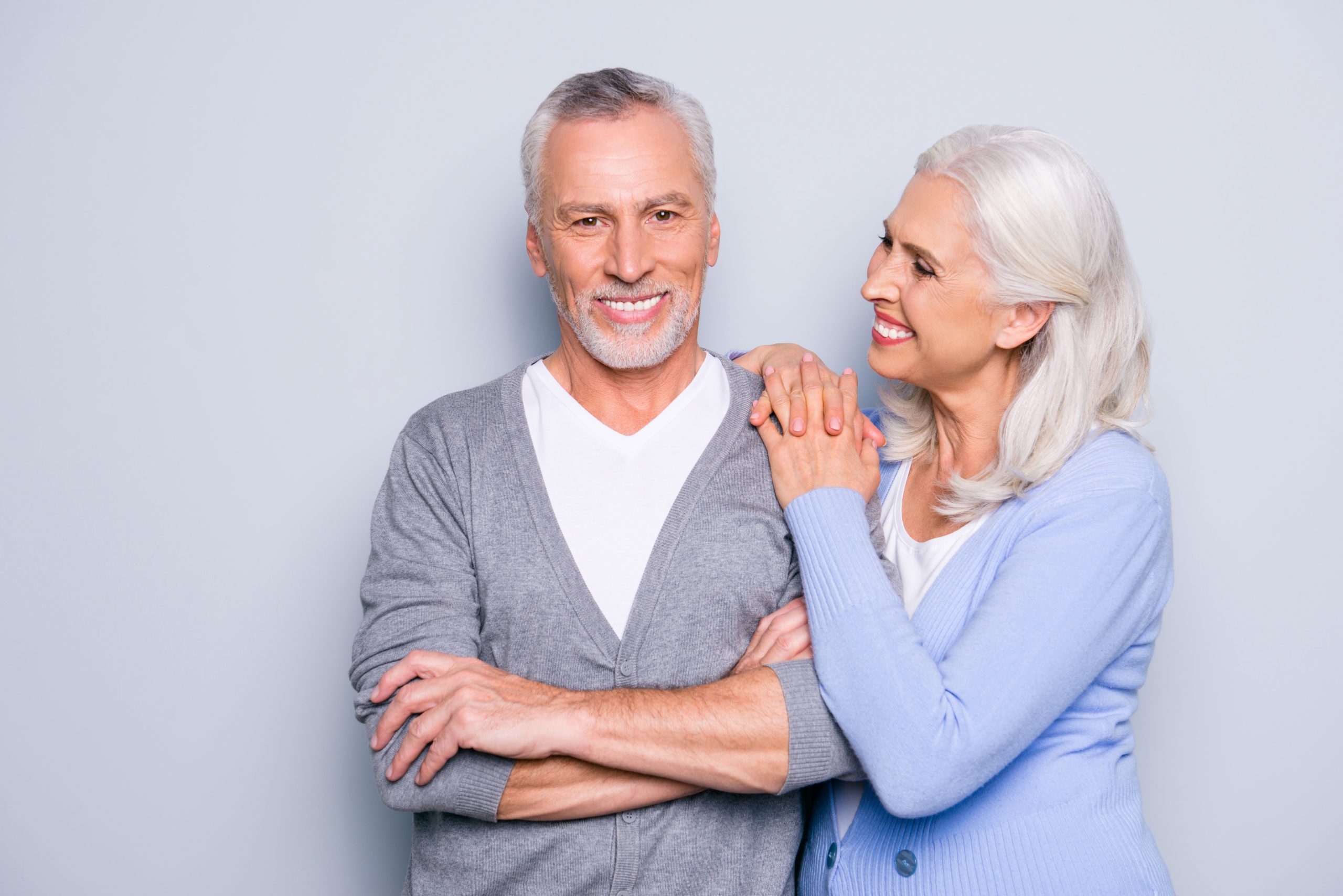 An older couple smiling confidently after dental implant treatment in Arlington Heights, IL